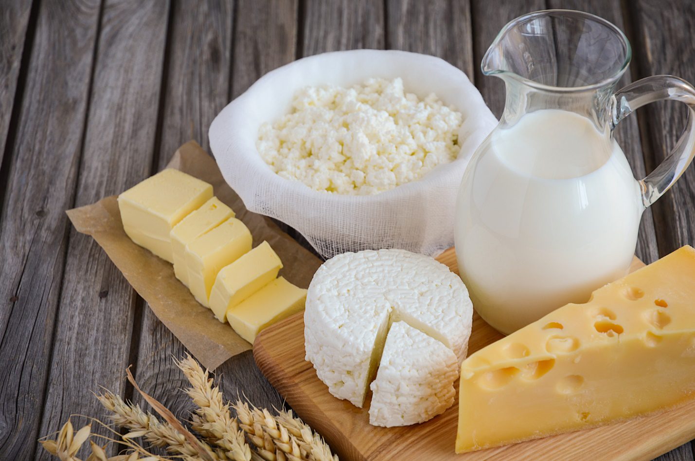 C:\Users\Dell\Downloads\fresh-dairy-products-milk-cheese-butter-cottage-cheese-with-wheat-rustic-wooden-background.jpg