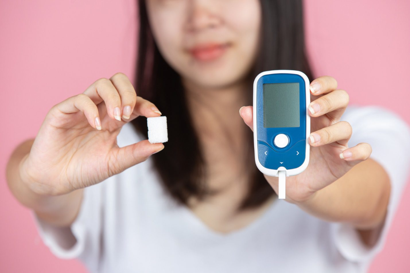 C:\Users\Dell\Downloads\world-diabetes-day-woman-holding-glucose-meter-sugar-cubes-pink-wall.jpg