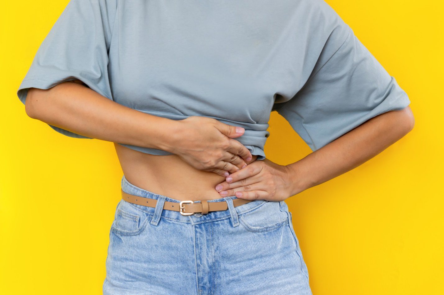 C:\Users\Dell\Downloads\cropped-shot-young-woman-holding-her-side-with-her-hands-isolated-color-yellow-background.jpg